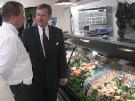 HHS Secretary Leavitt in seafood section at grocery store. Photo by Allyson Bell