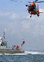 Photograph of: Coast Guard helicopter and rescue boat training to save lives