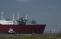 Photograph of: Tug boat pushes first LNG ship into position at Freeport terminal