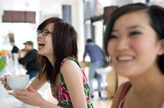 two girls eating and laughing