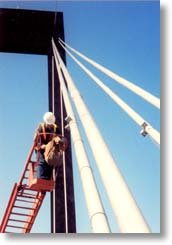 Technician working on anemometer on cable of Lulling Bridge in Louisiana.