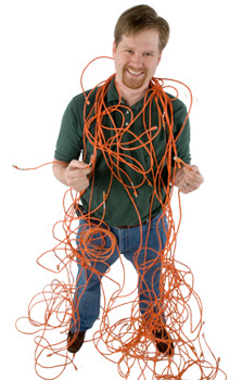 Image of an IT employee wrapped in network cables