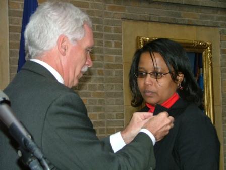 Photo of Secretary Schafer pinning a double eagle pin on a U S D A employee
