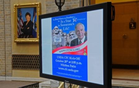 Photo of a T V monitor featuring a poster of Secretary Schafer on Mt. Rushmore