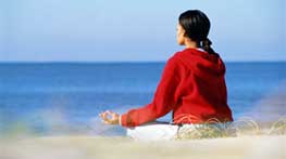 Photo of girl meditating on the beach