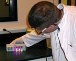 Laboratory worker holding fluorescent tubes