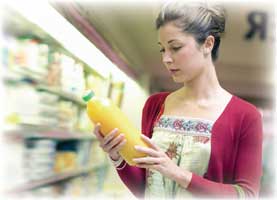 woman holding bottle of orange juice