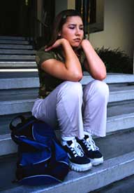 Photo of upset girl sitting on the steps