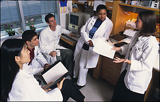 Medical students gather in a lab. Photo by Les Todd.
