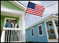 President George W. Bush stands with Fredy Omar outside his newly built home Tuesday, Aug. 29, 2006, in the Musicians' Village, where the President and Mrs. Bush hosted an outdoor luncheon for approximately 50 Habitat for Humanity volunteers in appreciation of their work at the 9th Ward home site.  White House photo by Eric Draper