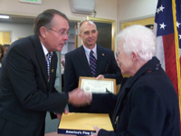 Mary Lou Connors receives Senator Crapo's Spirit of Freedom Award from Crapo staff member Bob Ford on behalf of her late husband, H. Norris Lynch. Lynch, a World War II veteran, received several medals and commendations for his military service and volunteer efforts in his later years.  Connors and Lynch were honored during Veterans Day Ceremonies November 11, 2008 at the Idaho Veterans Home in Boise.