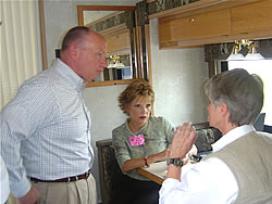 Congressman Brady and staff person Linda Manning help a constituent inside the Mobile District Office
