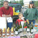 A family offers a variety of local wines at a market