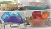 raw meat and poultry stored in containers separate from other foods in a refrigerator