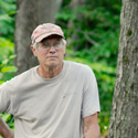 Dick Hotchkin standing next to a tree