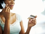 woman with credit card on telephone