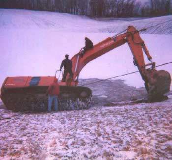 Figure 4. Divers hooking cables to excavator.