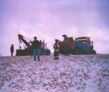 Figure 5. Tow truck operators watching extrication activities prior to their repositioning.