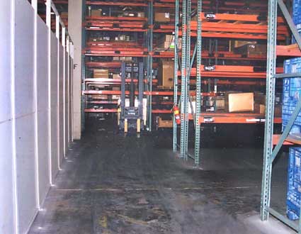 Photo 3 – View from the front of the forklift, showing the aisle ends and the wall to the side.