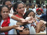 photo thumbnail:LT Christine Nemeti, a health services officer, distributes toothbrushes to Vietnamese families shortly after the Corpsâ€™ Pacific Partnership dental civic action program. 
 