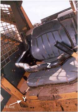 Skid steer loader. Frame where the head injury occurred. Also shows seat bar.