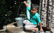 Uzbek boy gets water from well