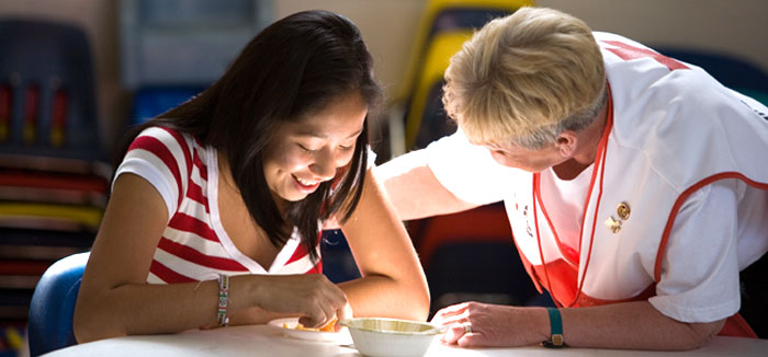 Emergency worker leaning over the shoulder of a girl