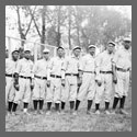 An African-American baseball team standing in a line.