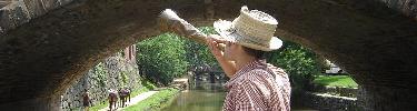 Photo of boatman blowing lockhorn.