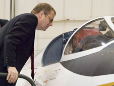 Dr. Johann-Dietriech Wörner, DLR Chairman of the Executive Board, peers into the cockpit of an ER-2 aircraft while touring Dryden Flight Research Center facilities.