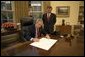 President George W. Bush signs the commission appointing John Roberts as the 17th Chief Justice of the United States prior to swearing-in ceremonies Thursday, Sept. 29, 2005, at the White House. White House photo by Eric Draper