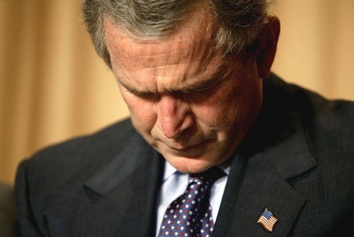 President George W. Bush prays during the National Prayer Breakfast in Washington, D.C., Thursday, Feb. 5, 2004. White House photo by Eric Draper.