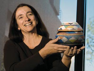 Laboratory researcher
Bette Korber of Theoretical
Biology and Biophysics
holds a hand-woven
basket she received from
children she met through
the Ark program in South
Africa.