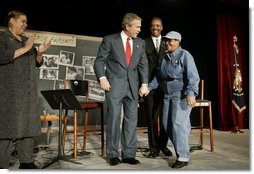 President George W. Bush greets Catherine Hill, who is an aunt and grandparent of D.C. students, after participating in a conversation on parental options and school choice at Archbishop Carroll High School in Washington, D.C., Friday, Feb. 13, 2004.  White House photo by Paul Morse