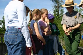 A park ranger shows students a beaver skull.