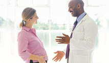 Image of health care provider talking with pregnant woman.