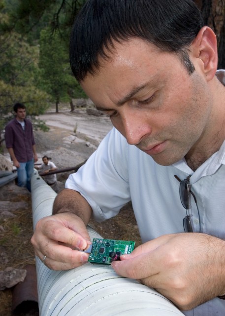 Computer scientist Sami Ayyorgun and his students deploy wireless sensors on a pipeline.                