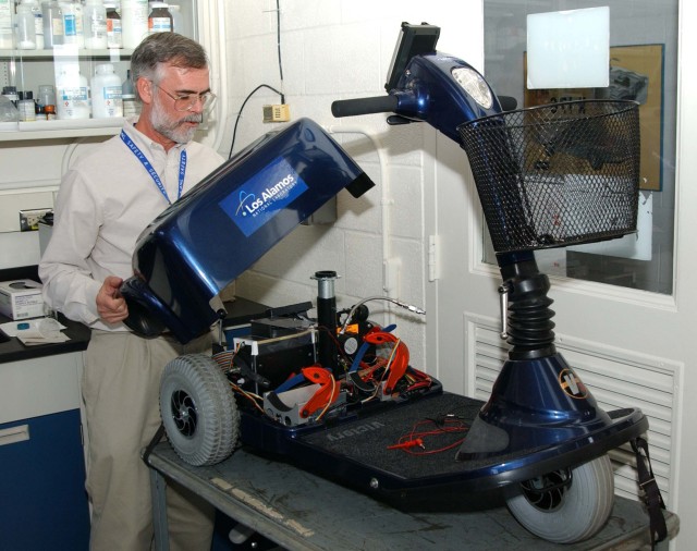 Laboratory affiliate Ken Stroh is shown with a Laboratory-built fuel-cell powered scooter.