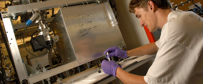 An engineering graduate student works on solar research in a lab on Centennial Campus. 
