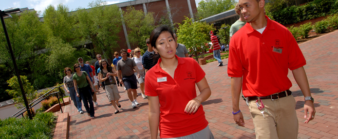University Ambassadors Heather Chang (left) and John York lead a campus tour for prospective students and their parents. 