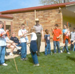 Park ranger shows students how to use the spearthrower.