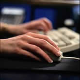 Image of a hand holding a computer mouse