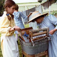 Junior historic interpreters wash clothes