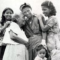 Manuel Perez, USN, returns to family as part of U.S. liberation forces, August 1944