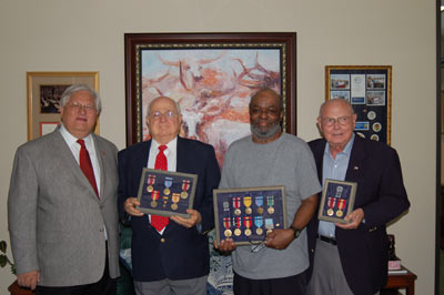 Congressman Marchant presents service awards to veterans at his district office.  