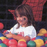 Child playing with colored balls at Funfest