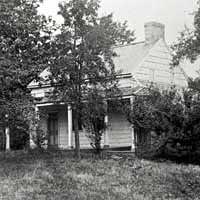 Poe Cottage, with Arthur Stoughton standing on the lawn, 1884