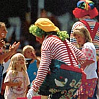 Scene from Cherry Festival with clowns and kids