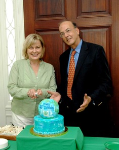Executive Director for the NIH Foundation, Amy Porter stands with Dr. Roger Glass before cutting Fogarty's blue and green globe cake.