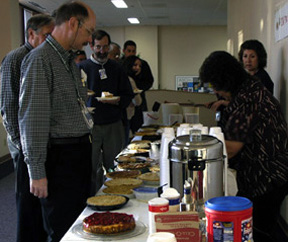 Alyn Ford of Telecommunications (CCN-4), John Morrison, Computing, Communications and Networking (CCN) Division leader, and Chris Kemper, CCN deputy division leader, look over some of the pies available for purchase at Thursday's CCN Division United Way fund raising event. For $5, Lab employees could purchase a slice of pie and a cup of coffee. Serving pie at right is Lucille Sanchez of the CCN Division Office, coordinator of the event, which brought in $1,300 for the Lab's United Way giving campaign.